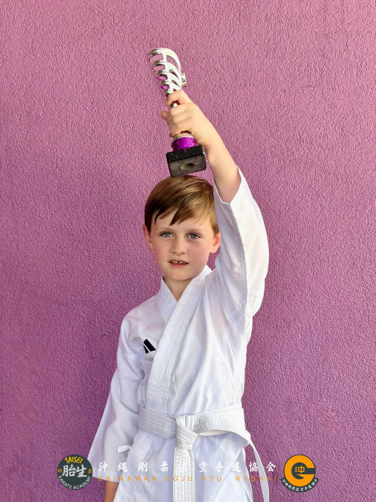 Young student holding his trophy above his head