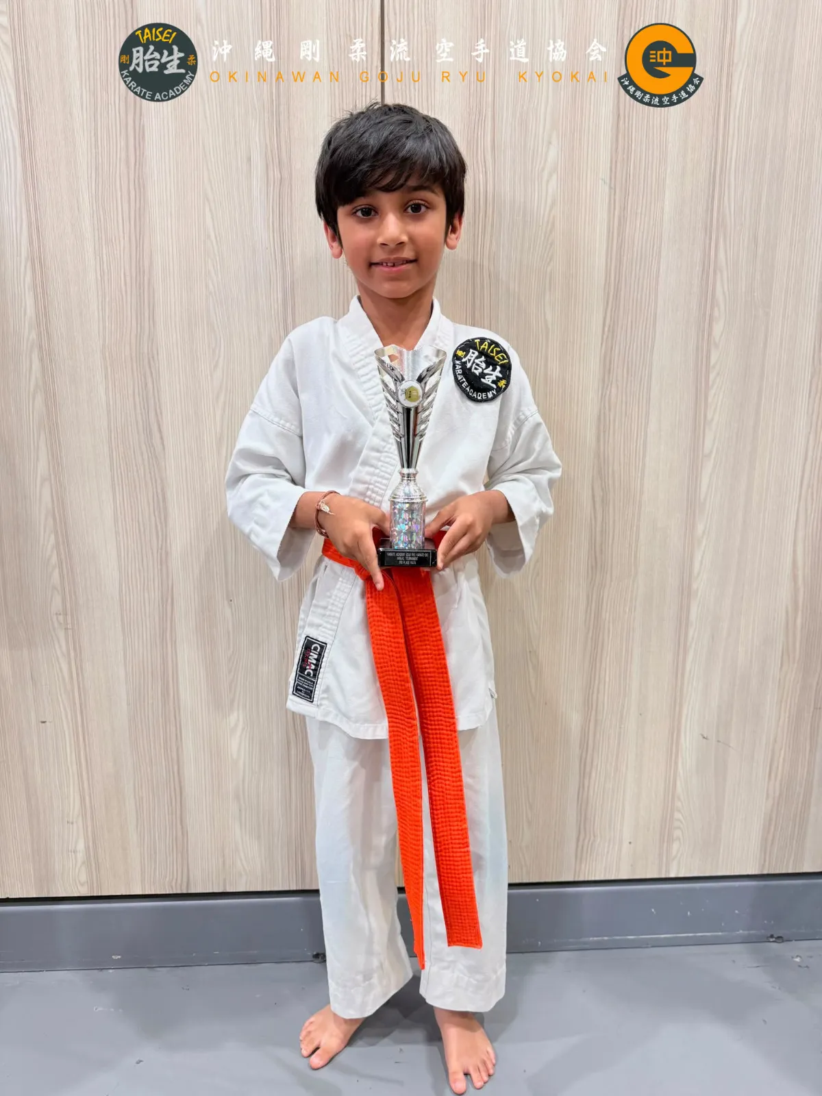 Young student posing with his tournament trophy