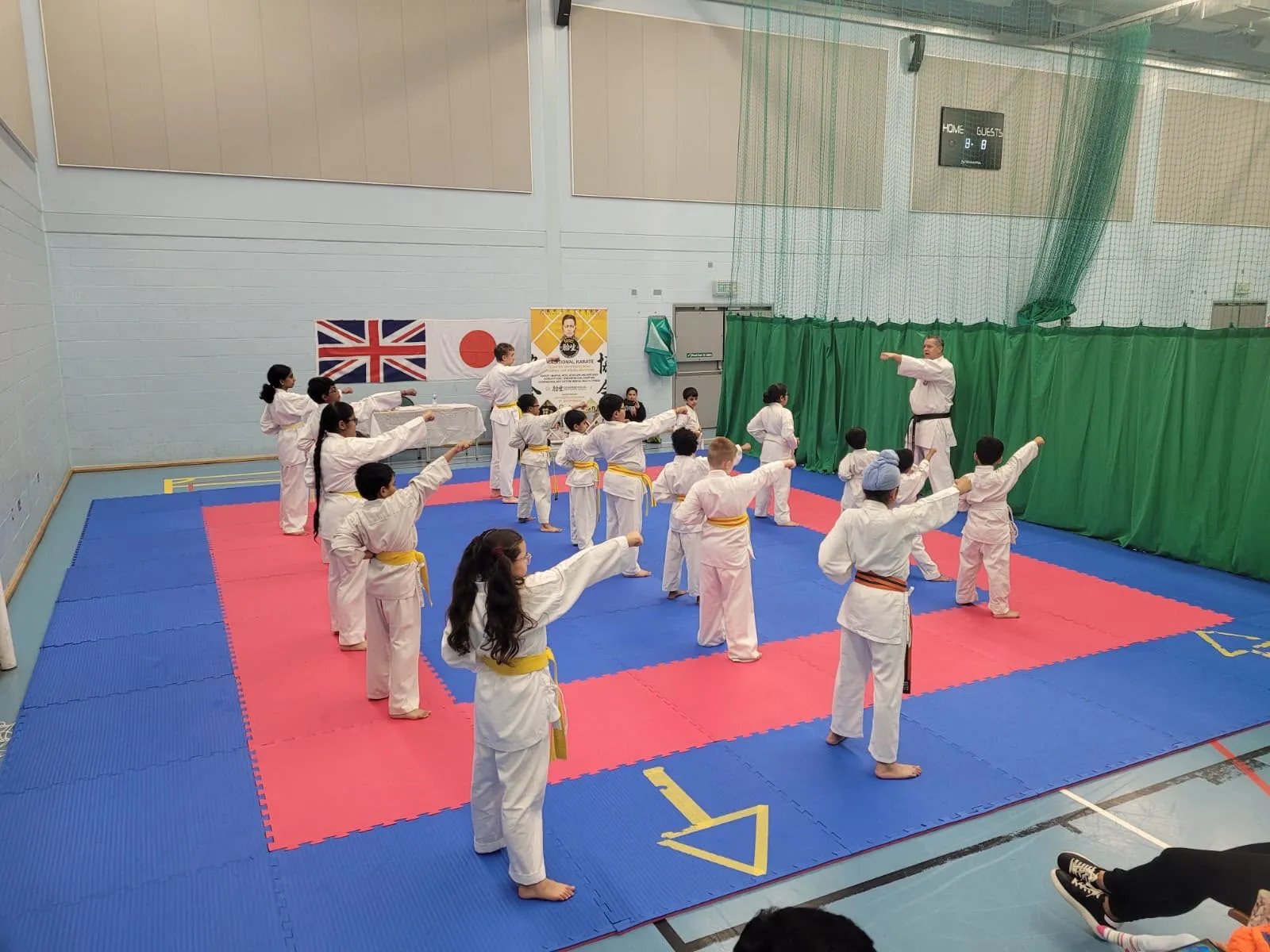 Large class practising a punching drill under instruction