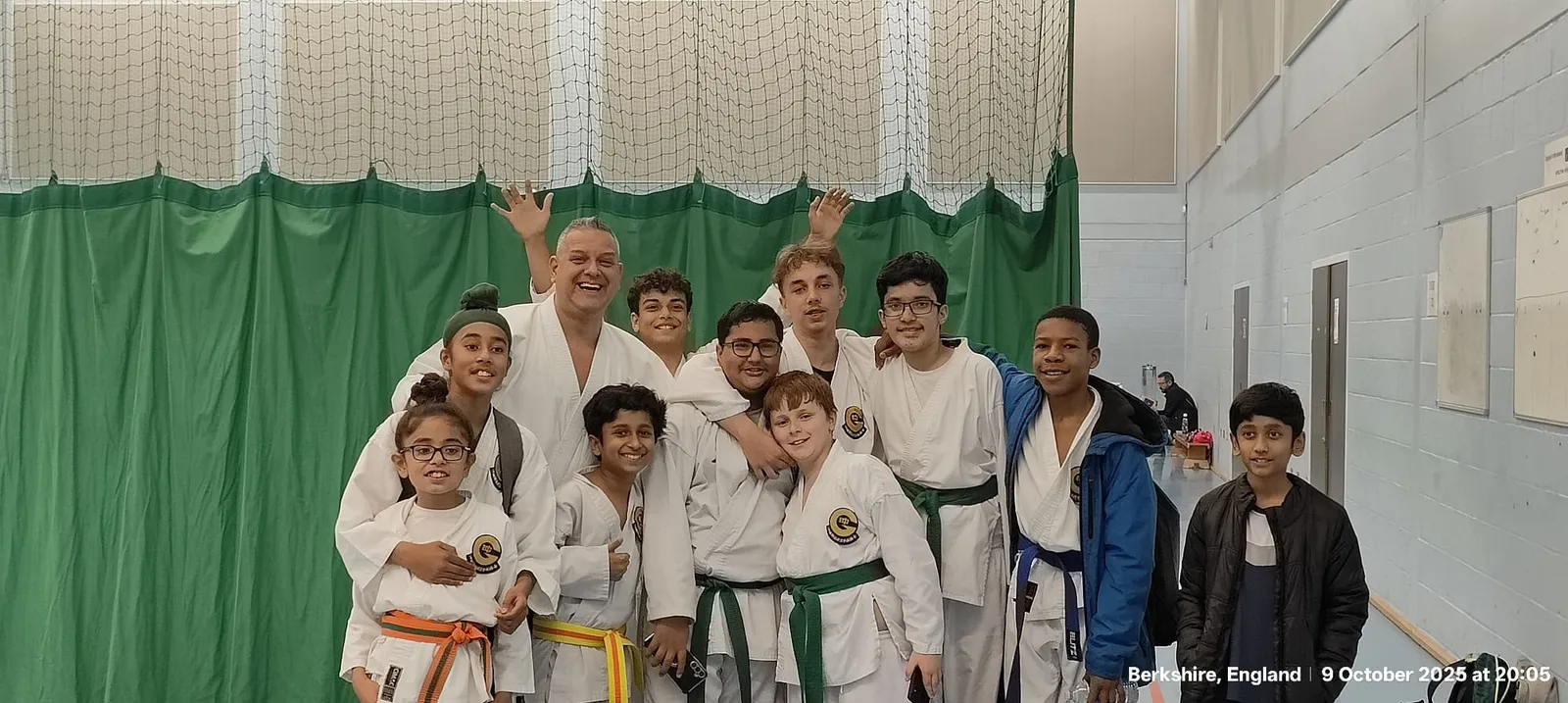 Group of teen and adult students smiling together after training