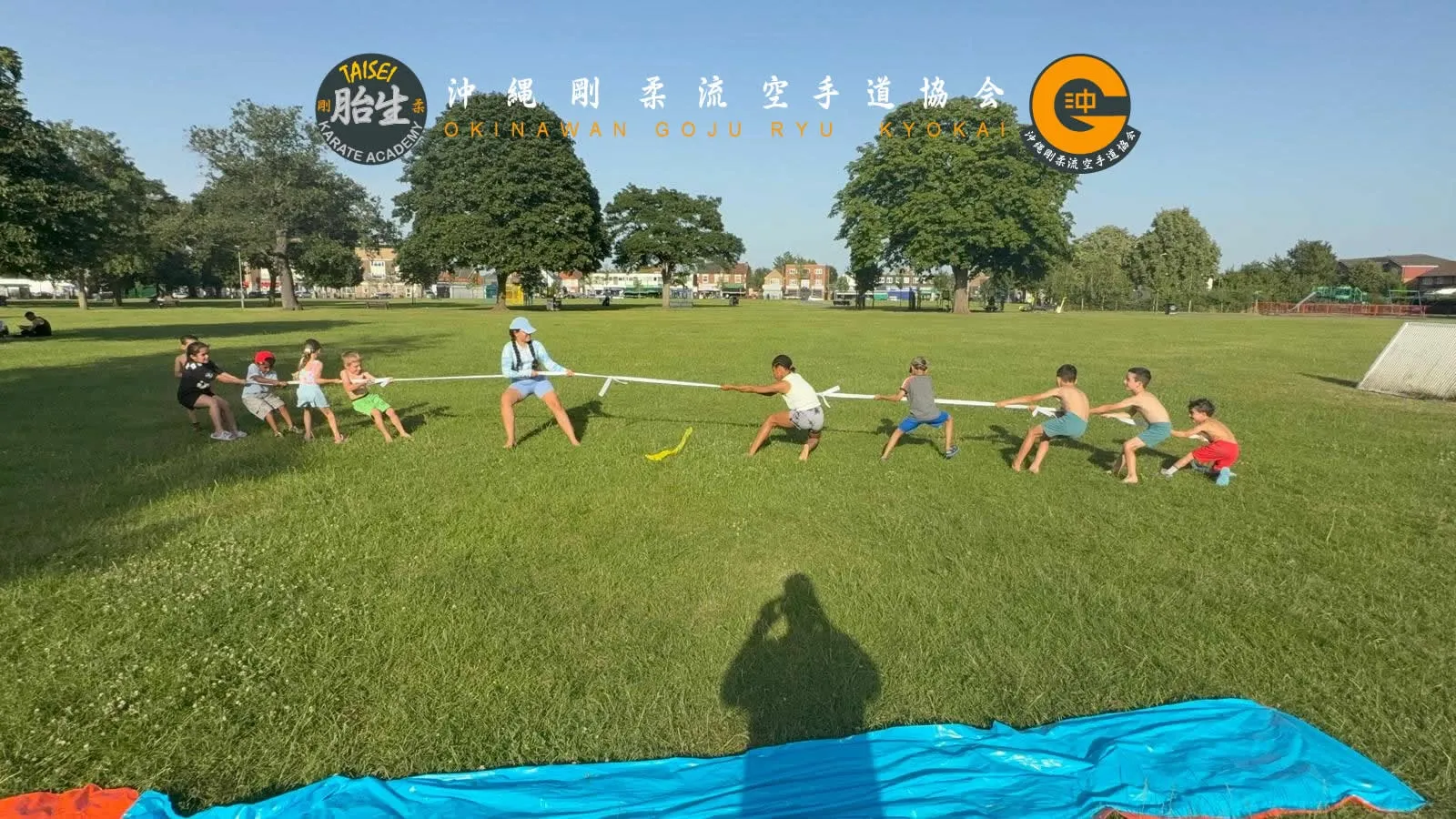 Students playing tug of war together at a club social event