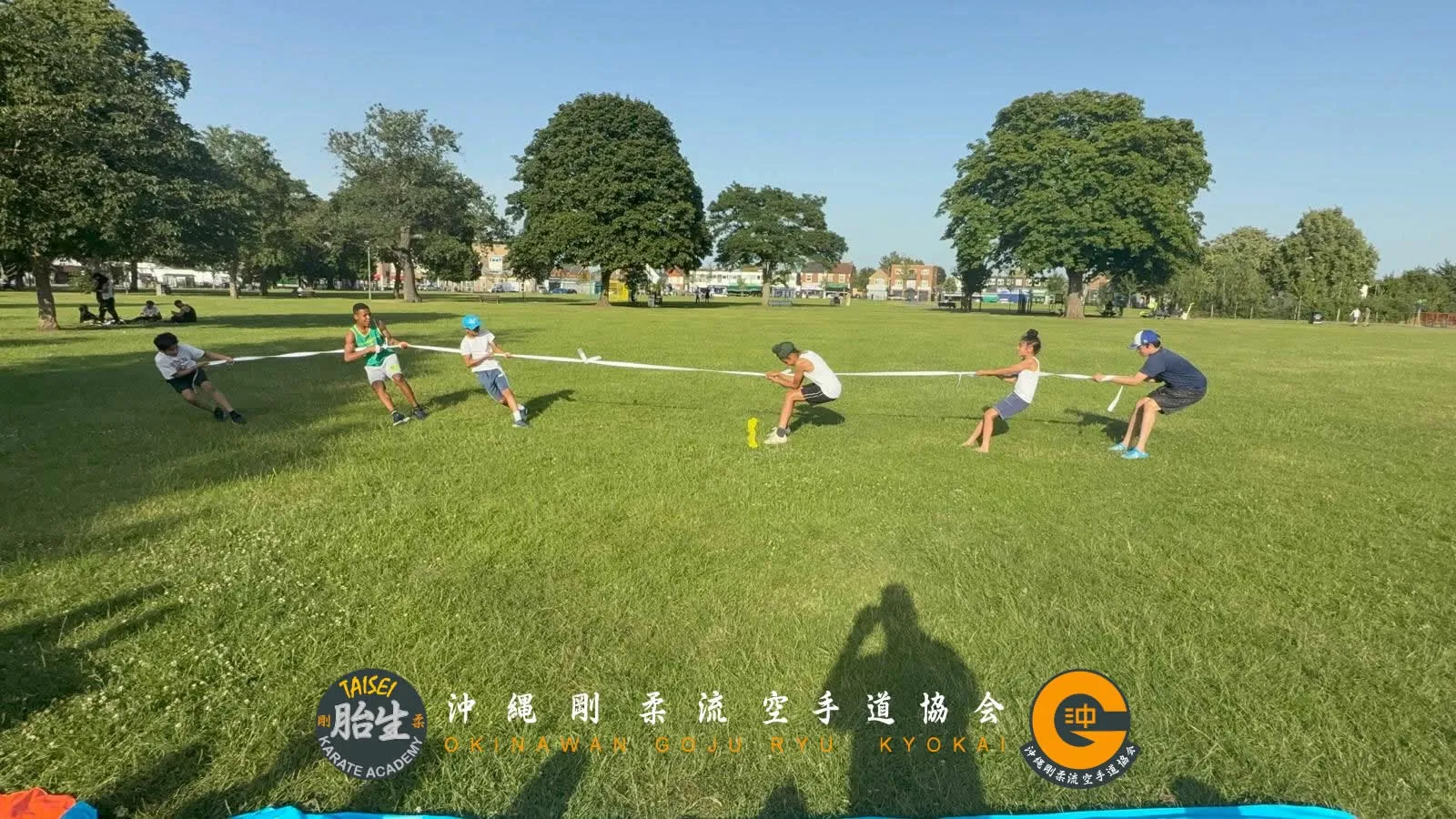 Students playing tug of war in the park